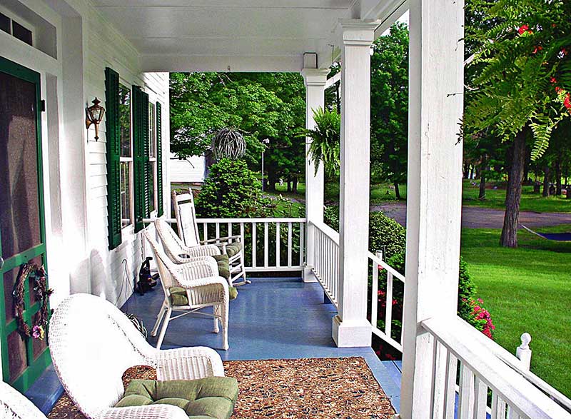 1870-Roebling-Inn-On-The-Delaware-front-porch rocking chairs trees