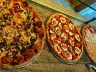 AJ's Pizza & Parm House pizzas on counter
