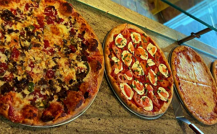 AJ's Pizza & Parm House pizzas on counter
