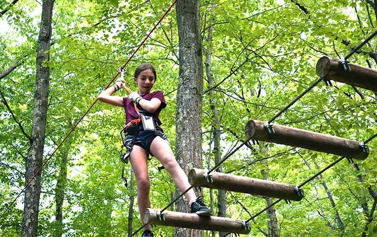 adventure center at skytop lodge girl on logs zip lining