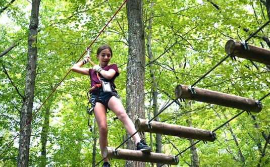 adventure center at skytop lodge girl on logs zip lining
