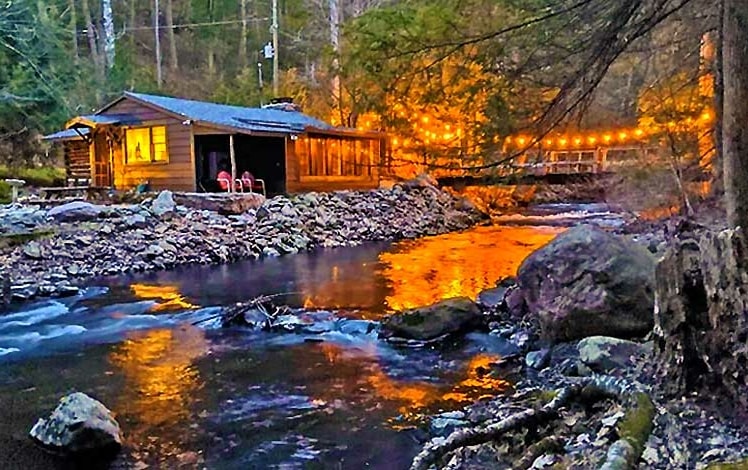 Big Al's Poconos Creek House exterior overlooking creek at night