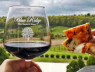 Blue Ridge Estate Winery glass of red wine and slice of pizza on deck