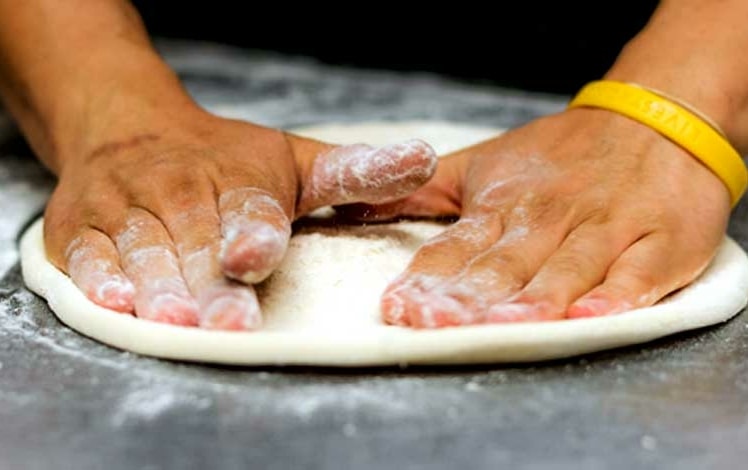 Brothers Pizzeria rolling the dough
