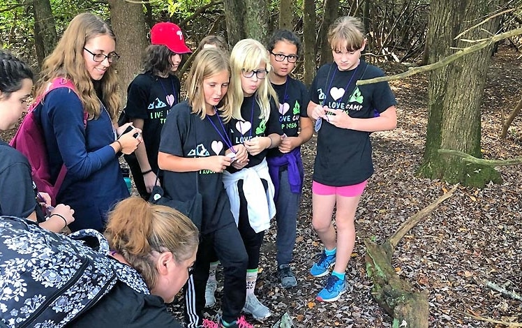 Camp Mosey Wood Girl Scout Camp girls discovering a toad