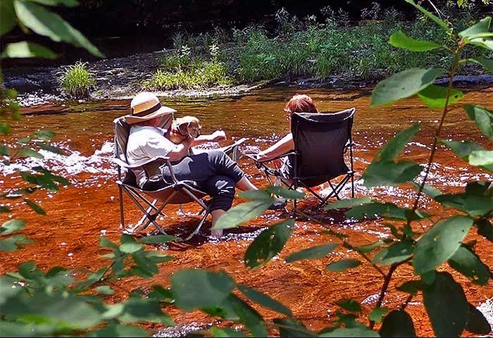 Covered Bridge Campsites Couple Relax in the Water