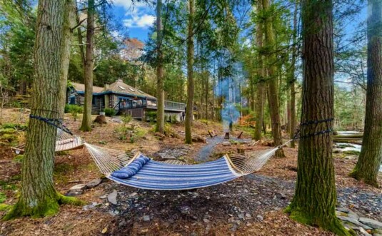 cozy creek cabin exterior and hammock by creek