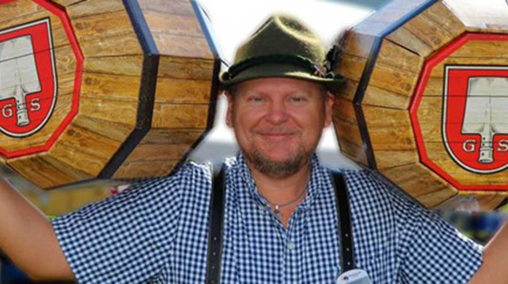 Oktoberfest at Blue Mountain man holding wooden kegs