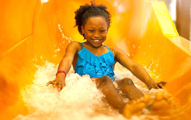 great wolf water park little girl on orange water slide