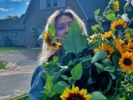 High Five Flower Farm Owner with Sunflowers