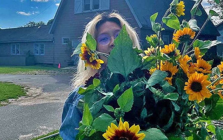 High Five Flower Farm Owner with Sunflowers