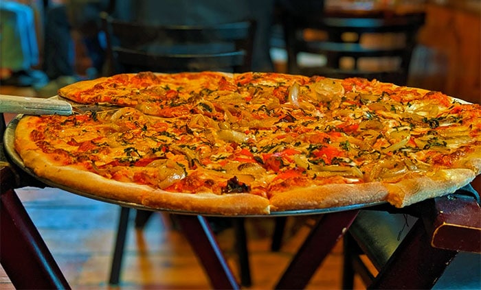 john's of arthur avenue large pizza on serving tray