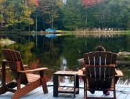 little pond lake house people in chairs on lakefront