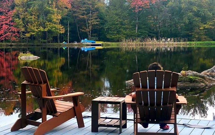 little pond lake house people in chairs on lakefront