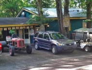exterior of building and parking lot with tractor and golf cart