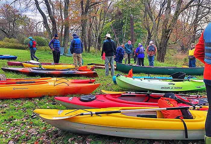 Pocono Heritage Land Trust group with kayaks on riverbank