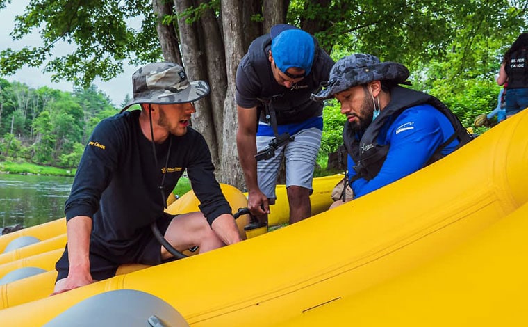 Silver Canoe and Whitewater Rafting 3 guys in a raft