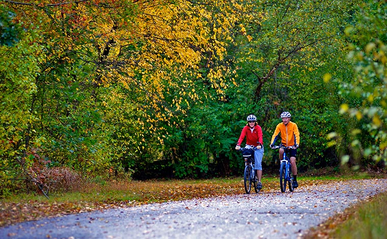 couple biking on the switchback trail in autumn