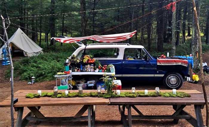 Sylvania Tree Farm truck and dining table at riverside campsite