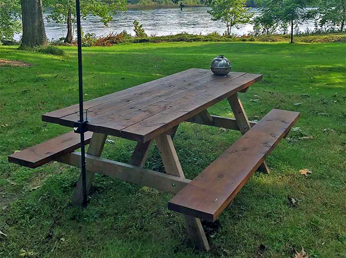 The Riverside Cottage picnic table on the river bank