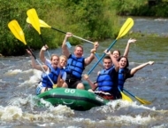 Whitewater Rafting Adventures family in boat on river