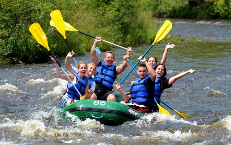 Whitewater Rafting Adventures family in boat on river