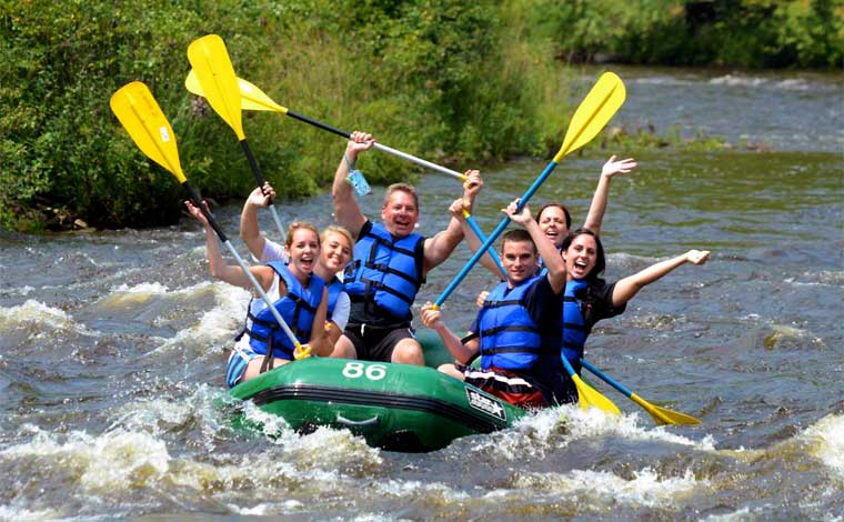 Whitewater Rafting Adventures family in boat on river