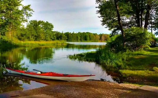 brady's lake shoreline and red kayak