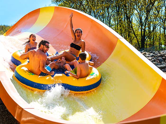people on giant orange and yellow slide