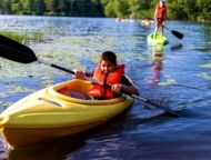 camp nesher kid in boat on lake