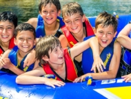 camp-starlight-boys-on-lake-in-a-tube