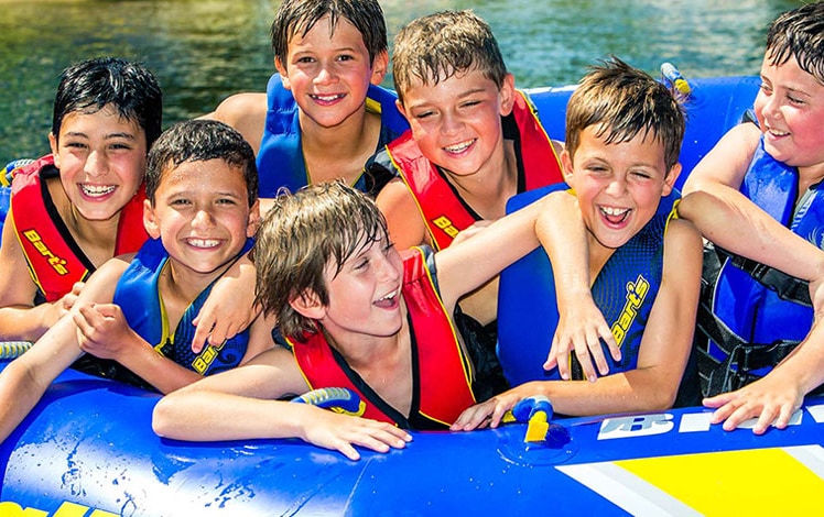 camp starlight boys on lake in a tube