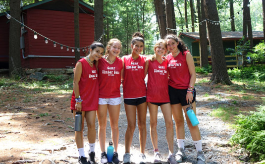 camp timber tops girls in front of cabins