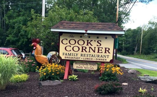 cook's corner family restaurant sign and rooster statue