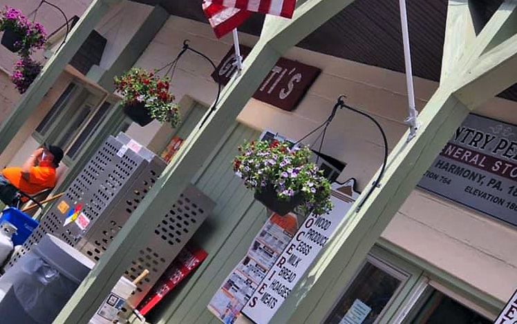 lake harmony country store exterior with flags and hanging flower baskets