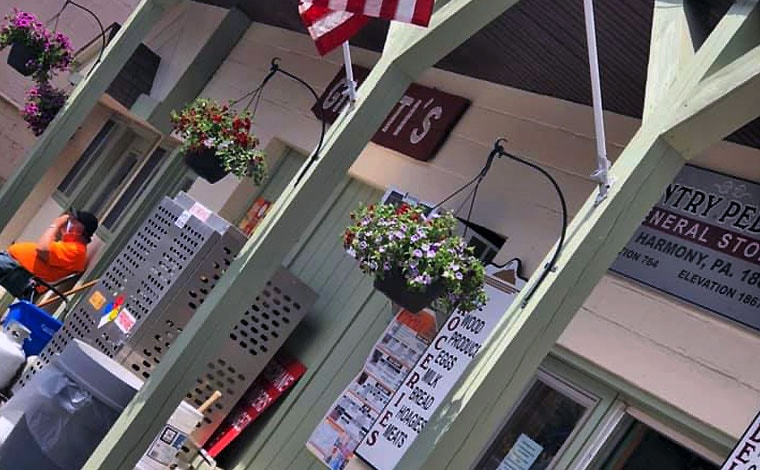 lake-harmony-country-store-exterior with flags and hanging flower baskets