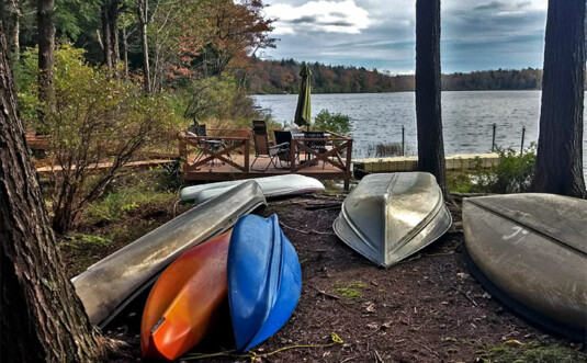 Lakewood Lodge canoes stored on river shore