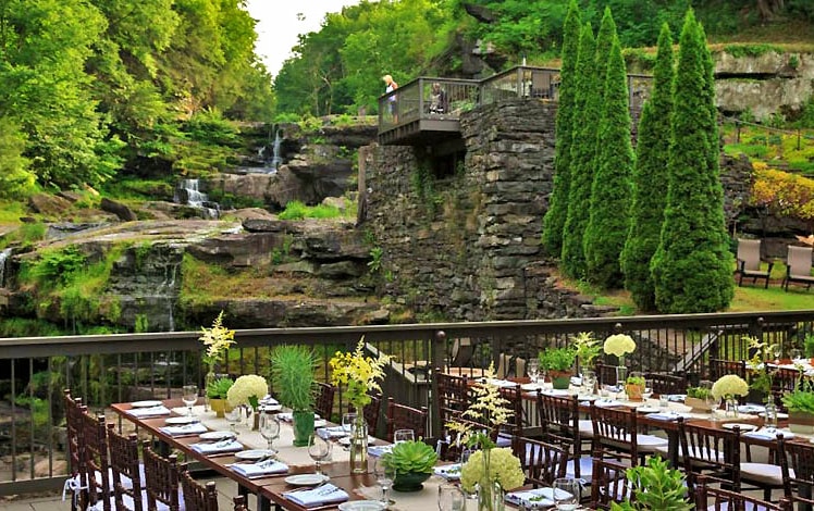 wedding tables on deck overlooking waterfall