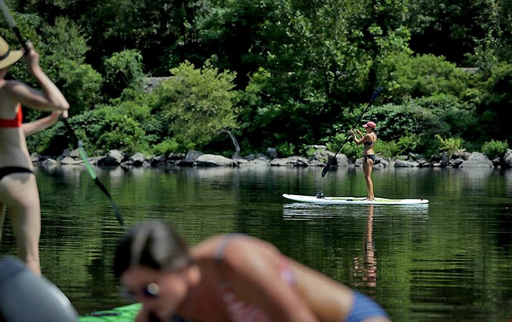 girl doing stand up paddling