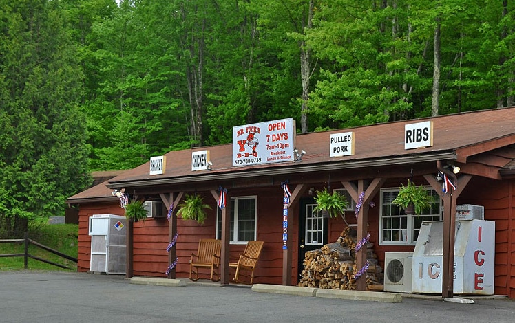 Mr Yock's exterior of one-story building in parking lot with a backdrop of trees