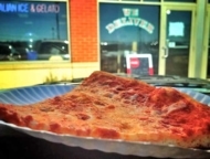 palumbo's pizza II slice in front of building exterior