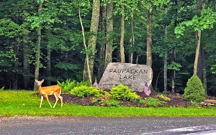 paupackan lake deer rock welcome sign