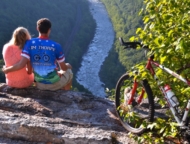 couple with bike overlooking the river