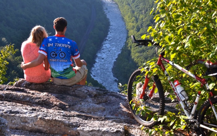 couple with bike overlooking the river