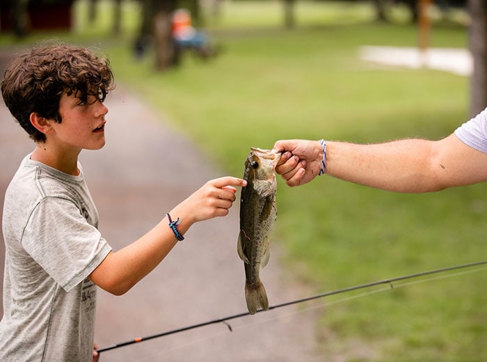 pocono-springs-summer-camp-boy-with-trout