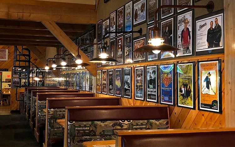 Roadies booths and concert posters hung on wall