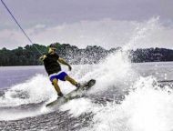 Rubber Duckie Boat Rentals man wakeboarding on lake