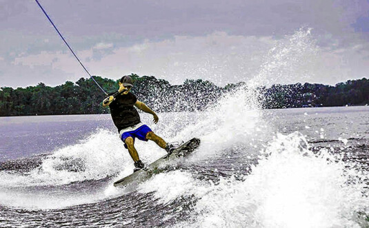 man wakeboarding on lake