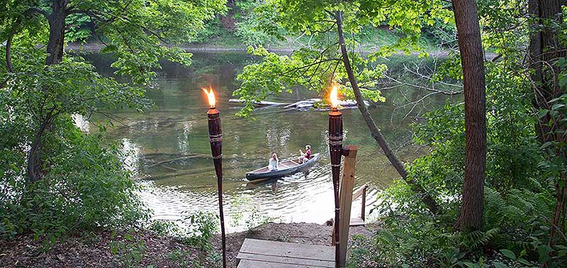 shawnee-river-trips-canoe-near-shore and tiki torches