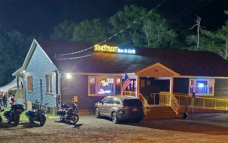 Side Street bar & grill exterior of building in the trees